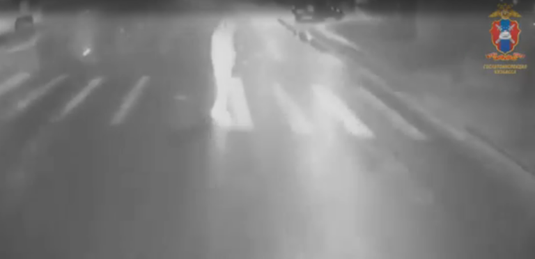 Проблесковые маячки патрульного автомобиля ДПС и пассажирский автобус на ночной улице Кемерова